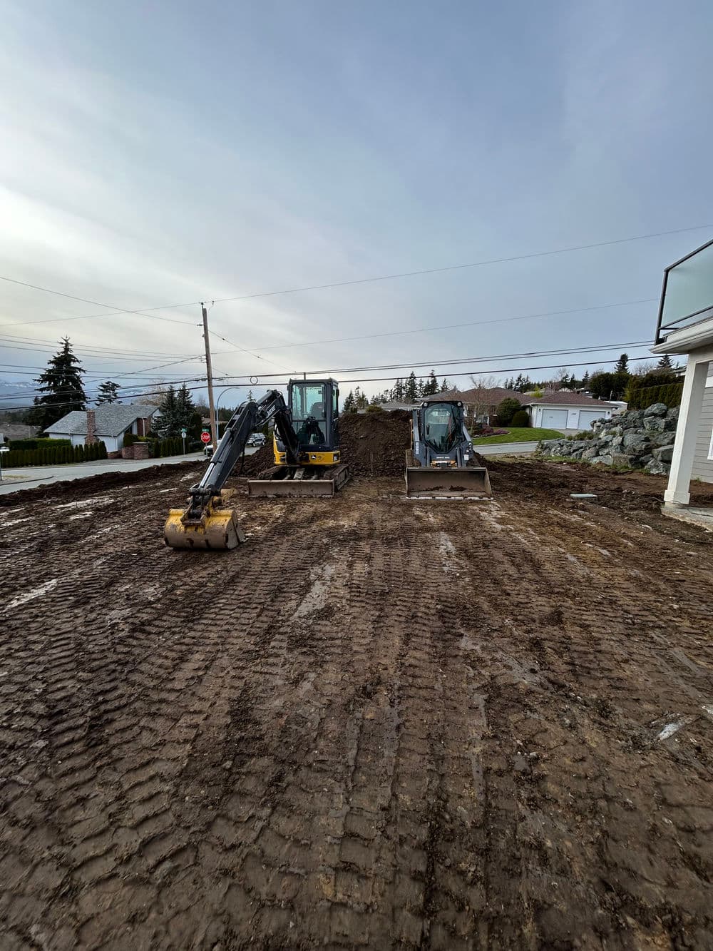 Excavators on a construction site preparing ground for building development.